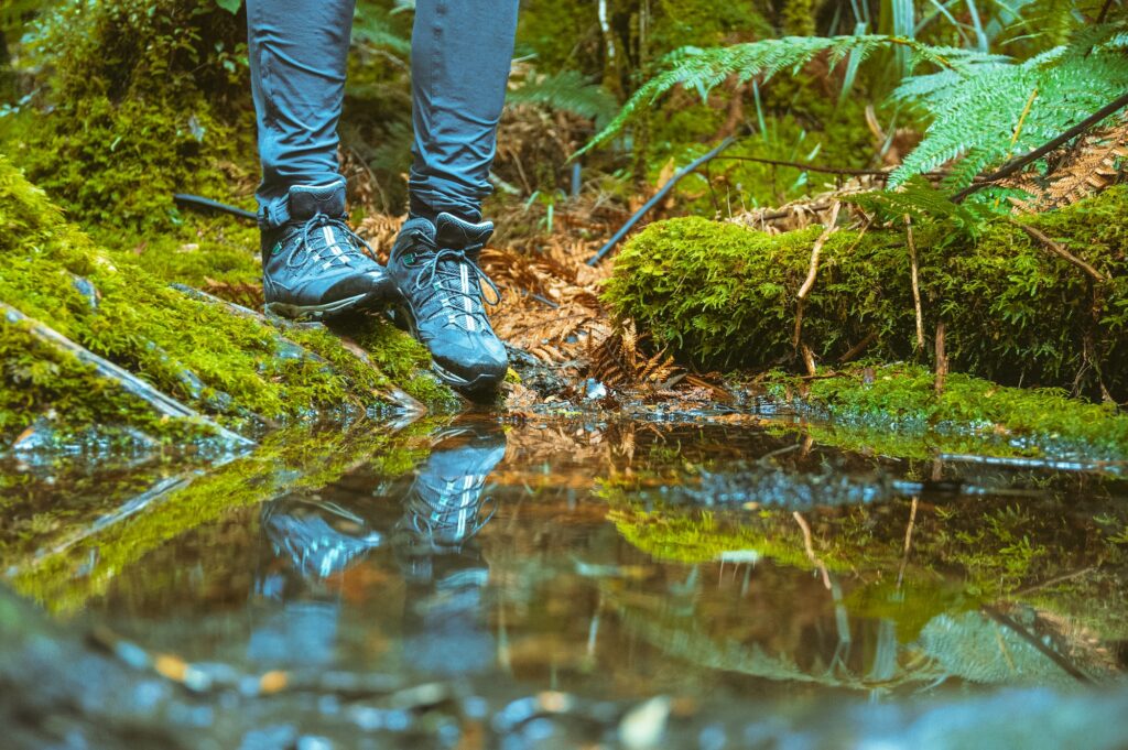 Hiking shoes boots water puddle reflection outdoor active nature hiking